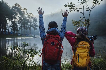 Couples who love to travel, take pictures Beatiful nature at Pang ung lake and pine forest at Mae Hong Son in Thailand.の写真素材