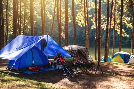 Asian woman travel nature camping on the Mountain see the lake in the mist at morning sunrise at Pang Ung , Mae Hong Son province, Thailand.の写真素材