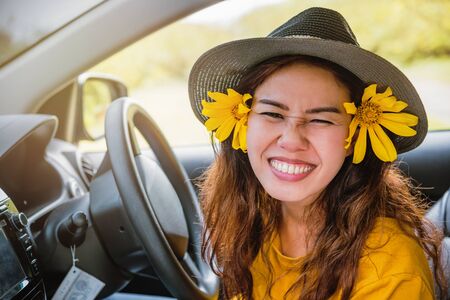 Asian women are on vacation. Drive happily traveling to the Mexican sunflower flower garden in...