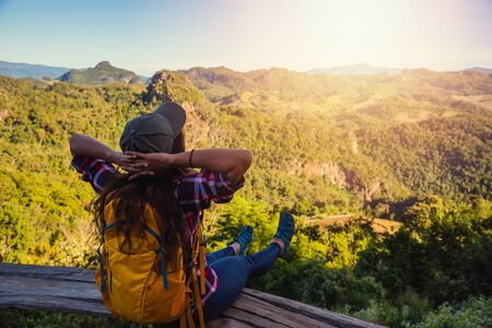 Natural travel of Asian women,While she was sitting and resting landscape view on the mountain,in Thailandの写真素材