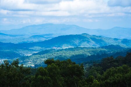 Fog over the mountains.In the rainy weather in the countryside. Stacked natural mountainsの写真素材