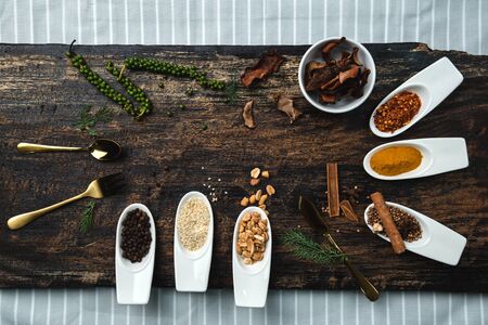 Various colorful herbs and spices on wooden table. Top view of spices and herbs. Spices and herbs...