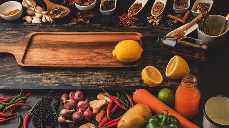 Spices for use as cooking ingredients on a wooden background with Fresh organic vegetables on wood. Healthy food herbs and spices. Organic vegetables on rustic wood.の写真素材