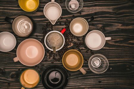 Many cups of coffee with beans on wooden table, top view. Flat lay composition with cups of coffee on background Old wood grain. Food photography, beverage.の写真素材