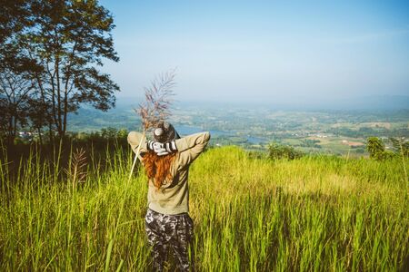 Asian woman travel nature. Travel relax. Standing natural touch grass on the Mountain at Khao-Khoâ. travel Thailandの写真素材