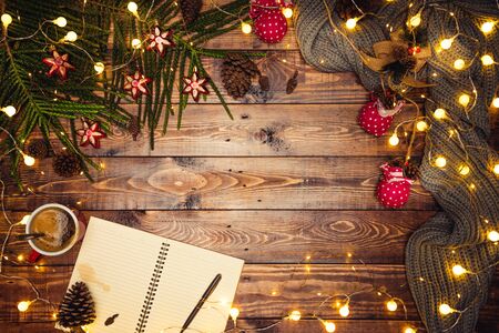 Merry Christmas and Happy New Year. Christmas composition. Gifts, fir tree branches, ball red decorations on a wooden background with copy space for your text. Christmas, winter new year concept. Led lights Bokeh, blurredの写真素材