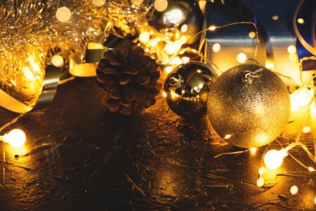 Christmas decoration balls on abstract bokeh black background with copy space and decorative LED lights. Merry Christmas and New Year.の写真素材