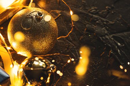 Christmas decoration balls on abstract bokeh black background with copy space and decorative LED lights. Merry Christmas and New Year.の写真素材