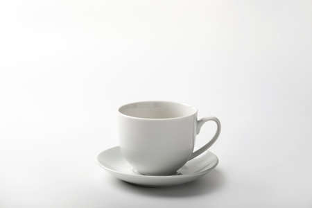 pouring a cup of coffee over white backgroundの写真素材