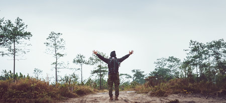 Asian man travel photograph nature. Travel relax. Walk on the path. Nature Study in the Jungle....