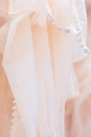 a background of wedding dresses hanging in the wedding salon
