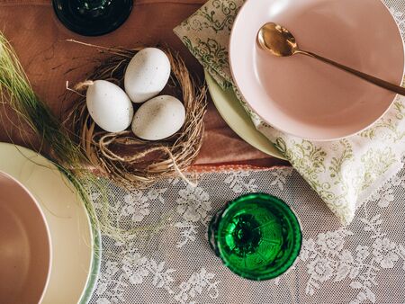 Easter eggs in a nest on a dark wooden table