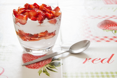 Strawberry dessert with spoon on tableの写真素材