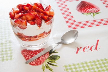 Strawberry dessert with spoon on tableの写真素材