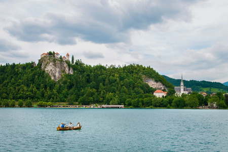 Bled castle with boat and lake in foreground in Sloveniaのeditorial素材