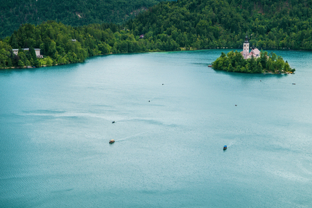 Bled island and boats on Lake Bled in Sloveniaの写真素材