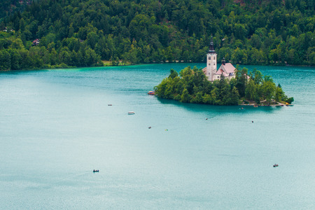 Bled island and boats on Lake Bled in Sloveniaの写真素材