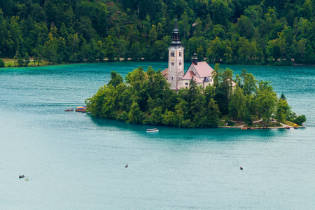 Bled island and boats on Lake Bled in Sloveniaの写真素材
