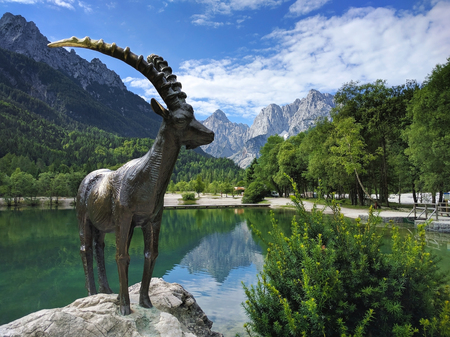 Lake Jasna and mountain goat statue closeup in Kranjska Gora in Sloveniaの写真素材