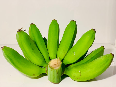 Green banana on a white background, close-up, isolated.の写真素材