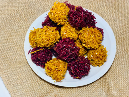 Salad of red cabbage, sweet potato and yellow carrot on white plate