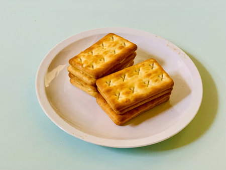 Biscuits in a white plate on a light blue background.
