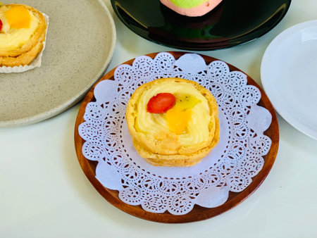 Egg tart on the wooden plate with copy space for text.