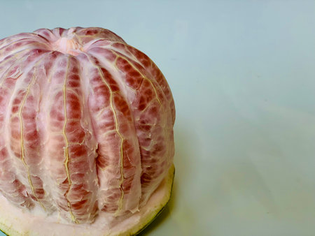 Peeled pomelo fruit on a white background close-upの写真素材
