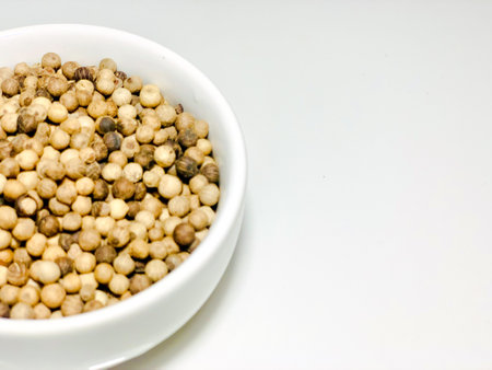 Coriander seeds in white bowl on white background, stock photoの写真素材