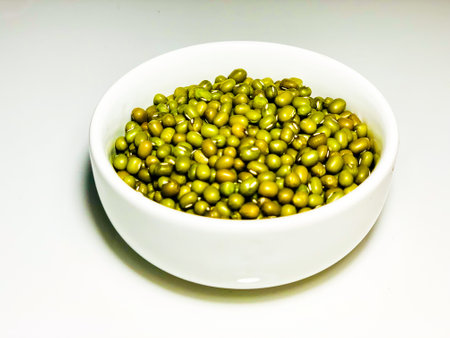 Green beans in a bowl on a white background, closeup of photoの写真素材