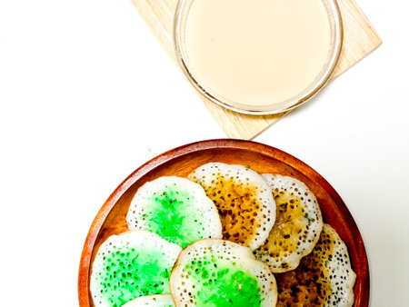 Pancakes in a wooden plate on a white background