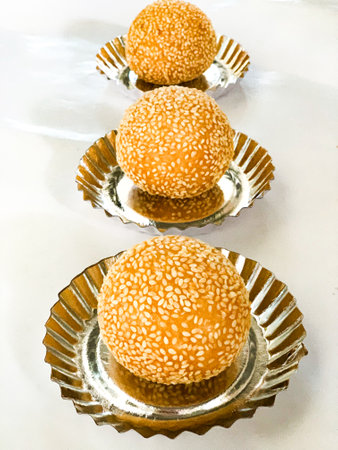 Delicious chinese bun with sesame seeds on a white background