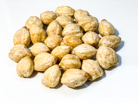Pile of dried nuts isolated on a white background.