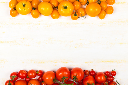 Different kinds of fresh tomatoes on grunge wooden surface, top viewの写真素材