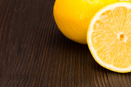 Group of fresh lemon on dark wooden tableの写真素材