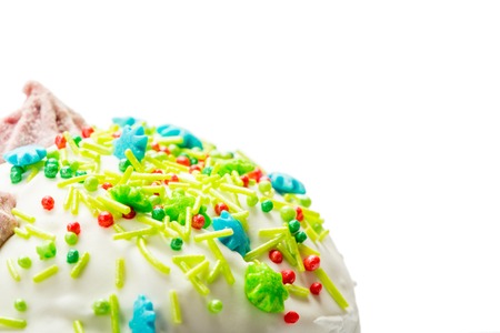 Top part of Easter cake with cream, colorful sugar sticks and dropsの写真素材