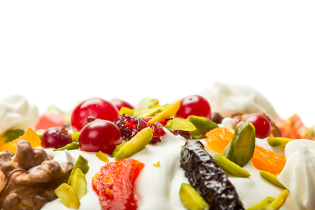 Top part of Easter cake with cream, cranberries, nuts and dried fruitsの写真素材