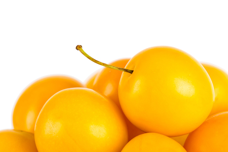 Handful of yellow cherry plums - isolated on whiteの写真素材