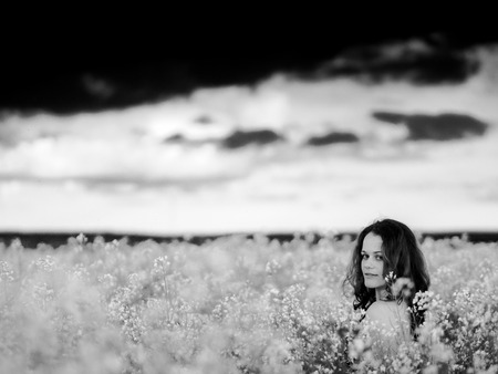 beautiful russian girl in a canola fieldの写真素材