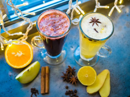 Fruit red tea with wild berries in glass cup, on wooden table, on bright backgroundの写真素材