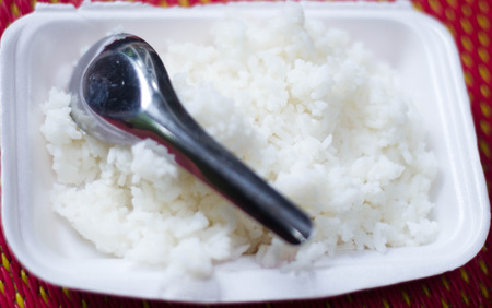 Rice in a bowl on a white backgroundの写真素材