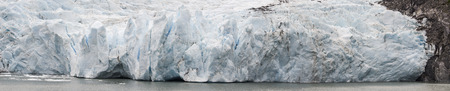 Wide face of the glacial pushes into a glacial lakeの写真素材
