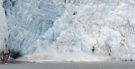 Ice falling from the glacier create quite a splash when they hit the water.の写真素材