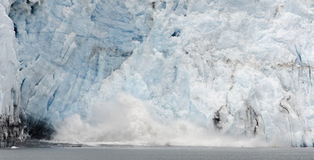 Ice falling from the glacier create quite a splash when they hit the water.の写真素材