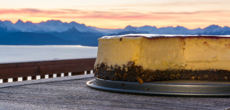 A cheese cake is cooling in the early morning with Kachemak Bay, Alaska, in the backgroundの写真素材
