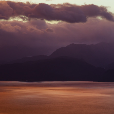 Sun rise sends all the shades of purple onto Kachemak Bay in Alaskaの写真素材