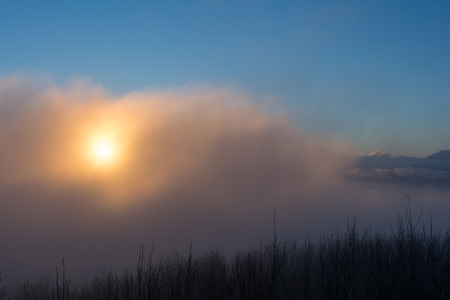 The sun glows orange in the morningの写真素材