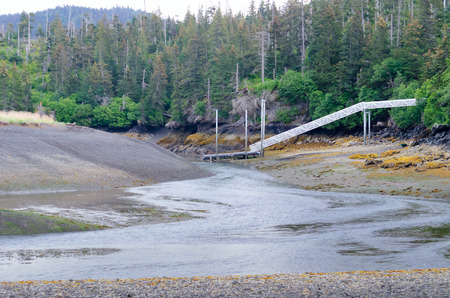 A boat dock stays high and dry as the tide heads to itの写真素材