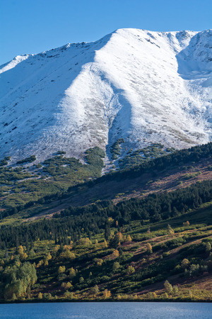 A light dusting of snow coveres the hillside signalling a change in the seasonの写真素材