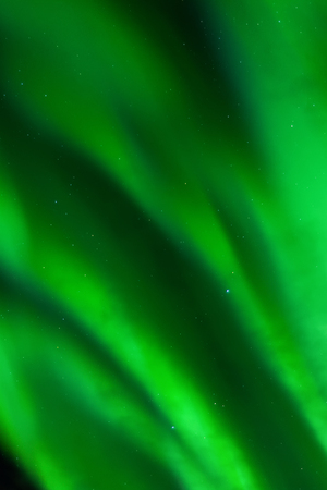 Bands of green aurora fill the entire sky.の写真素材